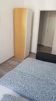 an empty room with a bed and a door at Modern Apartment Second Floor in Brussels