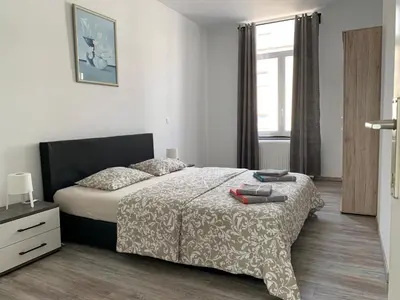 a bedroom with a bed and a window at Modern Apartment Second Floor in Brussels