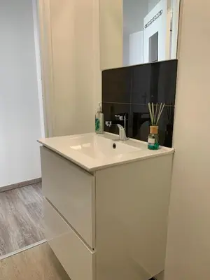 a white bathroom with a sink and a mirror at Modern Apartment Second Floor in Brussels