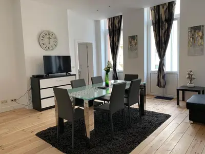 a dining room with a glass table and chairs at Modern Apartment First Floor in Brussels