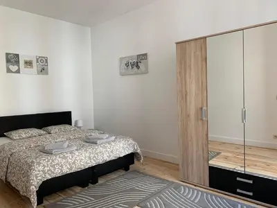 a bedroom with a bed and a sliding glass door at Modern Apartment First Floor in Brussels