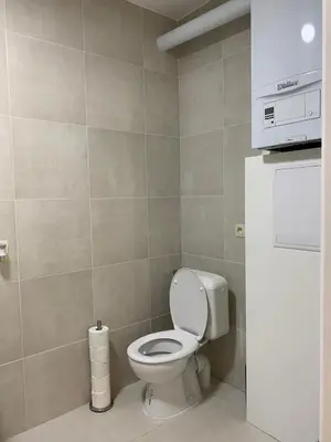 a bathroom with a toilet and a roll of toilet paper at Modern Apartment First Floor in Brussels