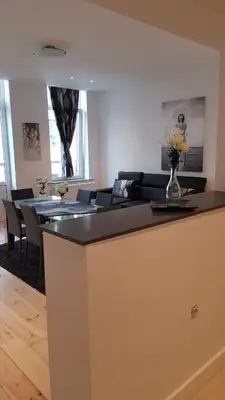 a living room with a couch and a table at Modern Apartment First Floor in Brussels