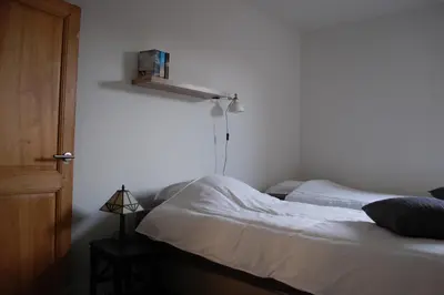 a bedroom with a bed and a shelf on the wall at Rubbensloft in Zele