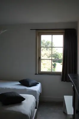 a room with two beds and a window at Rubbensloft in Zele