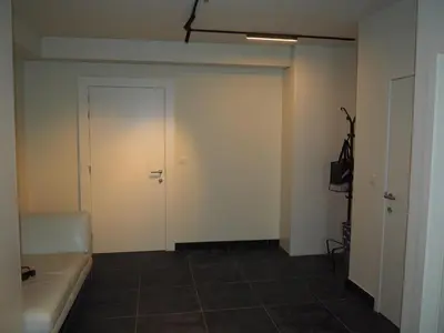 an empty room with a couch and a door at Rubbensloft in Zele