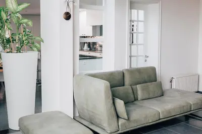 a living room with a couch and a chair at Gadering in Zele