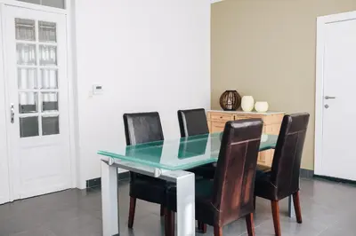 a dining room with a glass table and chairs at Gadering in Zele