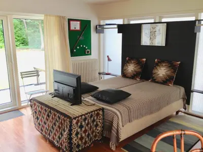 a bedroom with a bed with a television on a table at B+B GOLF SCHILDE in Schilde