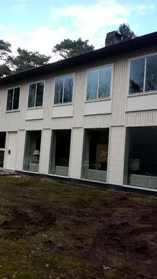 a building with many windows on the side of it at B+B GOLF SCHILDE in Schilde