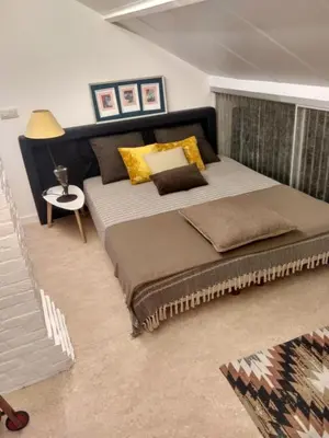 a bedroom with a large bed and a table at B+B GOLF SCHILDE in Schilde