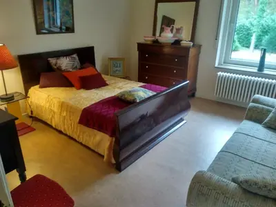 a bedroom with a bed and a dresser and a couch at B+B GOLF SCHILDE in Schilde