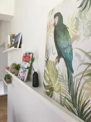 a painting of a parrot sitting on a shelf at Scheldewegel Vakantiehuis in Schelderode