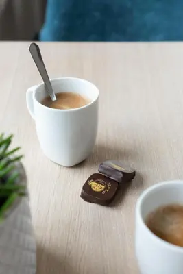 a table with a cup of coffee and a wallet at B&B Hof Beygaert in Aalst