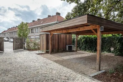 a wooden pavilion in front of a house at B&B Hof Beygaert in Aalst