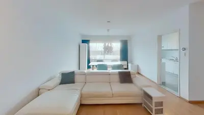a living room with a white couch and a table at nice and cosy apartment in Edegem
