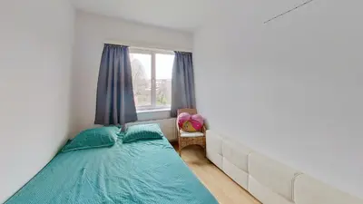 a bedroom with a large bed and a window at nice and cosy apartment in Edegem