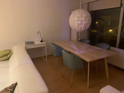 a living room with a wooden table and a couch at nice and cosy apartment in Edegem
