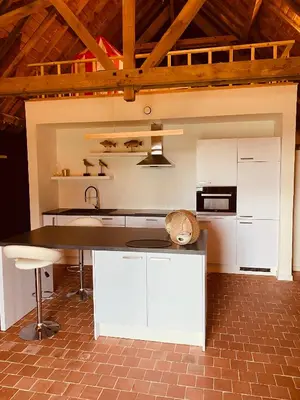 a kitchen with white cabinets and a counter top at Hotel Colonie 7 in Merksplas