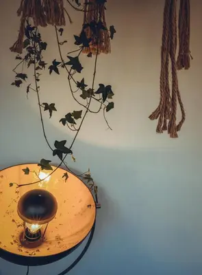 a lamp on a table with bats on a wall at Hotel Colonie 7 in Merksplas