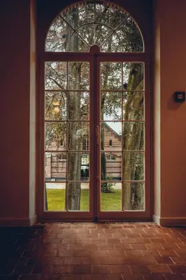 an open door with a view of a tree at Hotel Colonie 7 in Merksplas