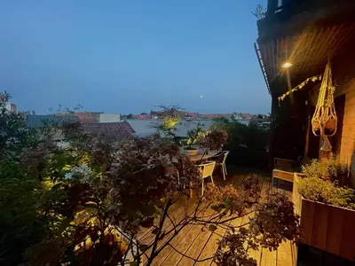 a balcony with a table and a view of the water at Desk Till Dawn in Ghent