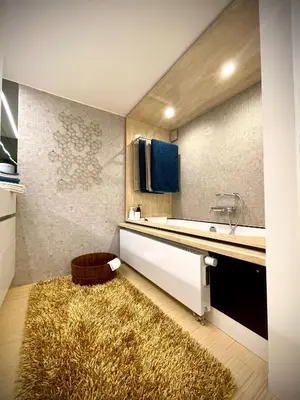 a bathroom with a sink and a counter with a rug at Desk Till Dawn in Ghent