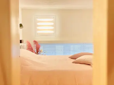 a bedroom with a bed and a window at Desk Till Dawn in Ghent