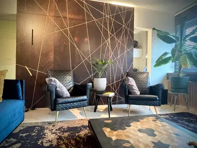 a living room with two chairs and a wall at Desk Till Dawn in Ghent