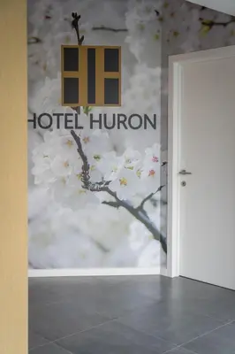 a door to a hotel hilton sign with aakura tree at Hotel Huron in Mol
