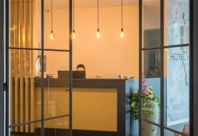 an office with a desk with a laptop on it at Hotel Huron in Mol
