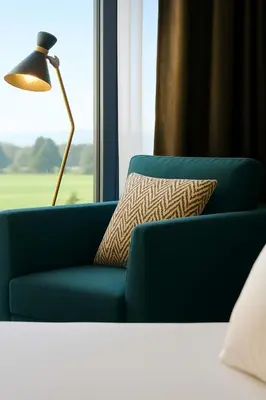 a blue couch with a pillow next to a window at OFF in Wavre