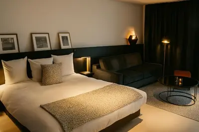 a hotel room with a bed and a couch at OFF in Wavre