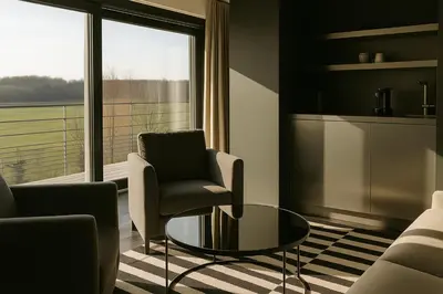 a living room with a table and chairs and a window at OFF in Wavre