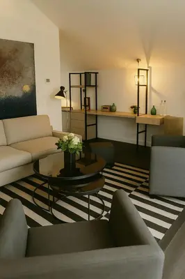 a living room with couches and a table with flowers at OFF in Wavre