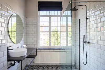 a bathroom with a sink and a shower and a mirror at OsTi in Ghent