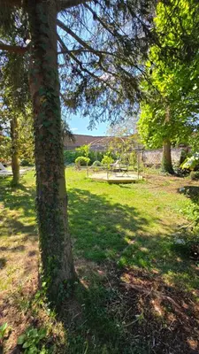 a group of trees in a park with a picnic table at OsTi in Ghent