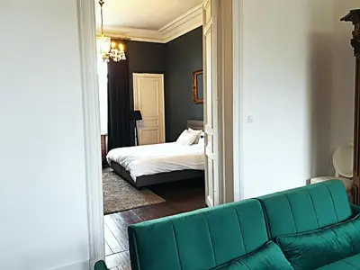 a living room with a couch and a bed at OsTi in Ghent