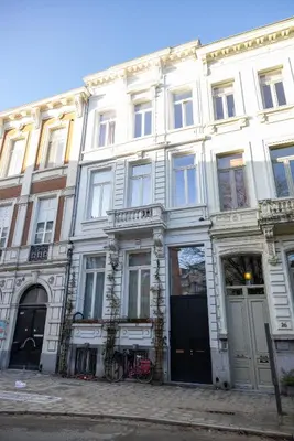 a large white building with bikes parked in front of it at Heaven in Antwerp in Antwerp