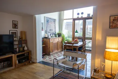 a living room with a chair and a television at Heaven in Antwerp in Antwerp