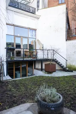 a building with a balcony and a staircase in a yard at Heaven in Antwerp in Antwerp