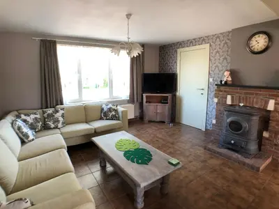 a living room with a couch and a fireplace at De Holsterhoeve in Beringen