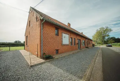 a brick building on the side of a road at De Holsterhoeve in Beringen