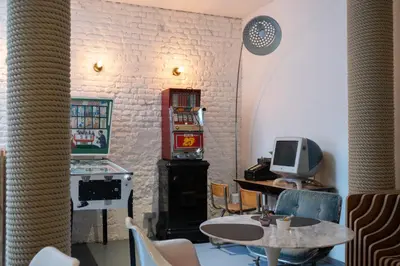 a room with a table and a tv and a counter at Hotel Retro in Brussels