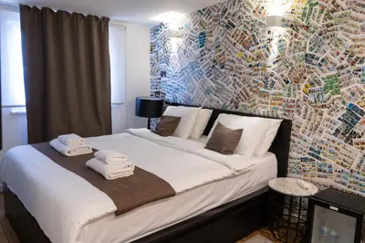 a bedroom with a large bed with towels on it at Hotel Retro in Brussels