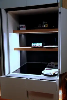 a kitchen with an open refrigerator with a stove at B&B AubergInn in Tessenderlo