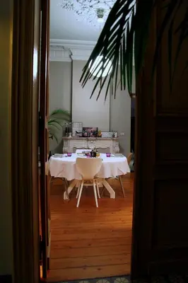 a table with a white table cloth on it in a room at B&B AubergInn in Tessenderlo
