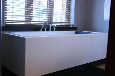 a white sink in a room with a window at B&B AubergInn in Tessenderlo