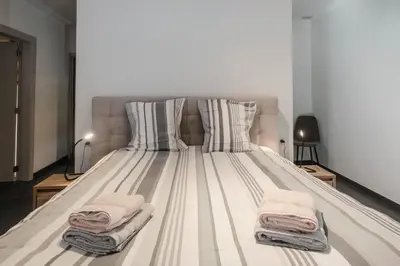 a large bed with two towels on top of it at Craywinckelhof Wagenhuis Horst in Lubbeek