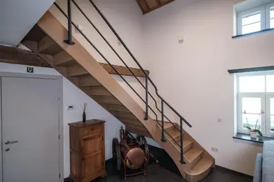 a wooden staircase in a living room at Craywinckelhof Wagenhuis Horst in Lubbeek
